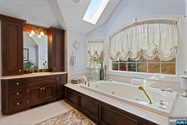 a bath room with a sink and a large mirror
