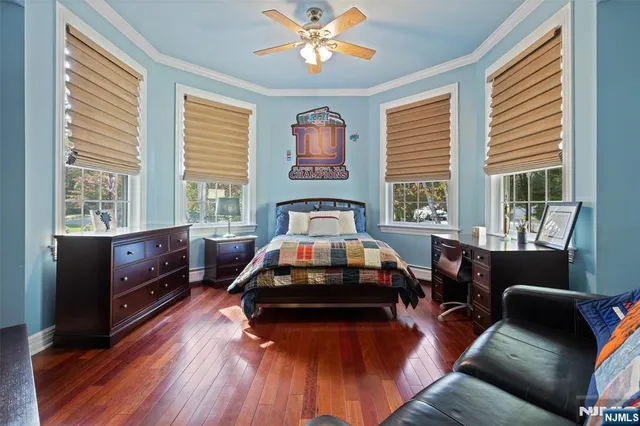 a bedroom with a bed and a couch next to a window