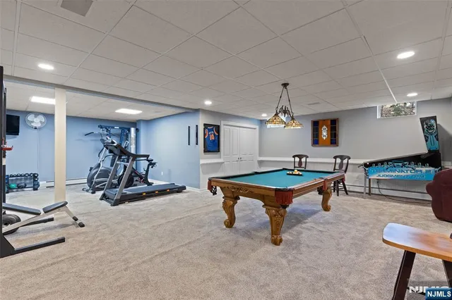 a living room with furniture gym equipment and a chandelier
