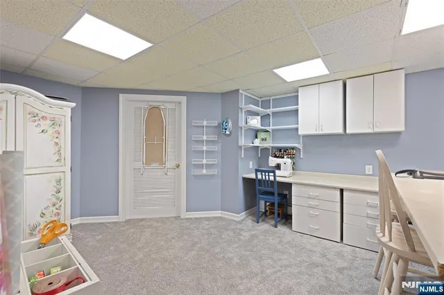 a living room with furniture pool table and a rug