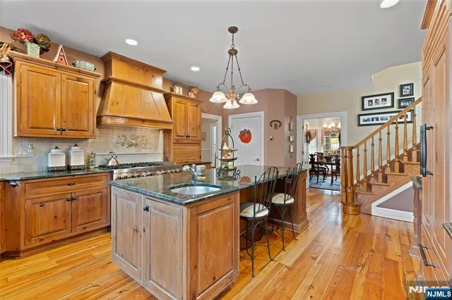 a kitchen with sink cabinets and wooden floor