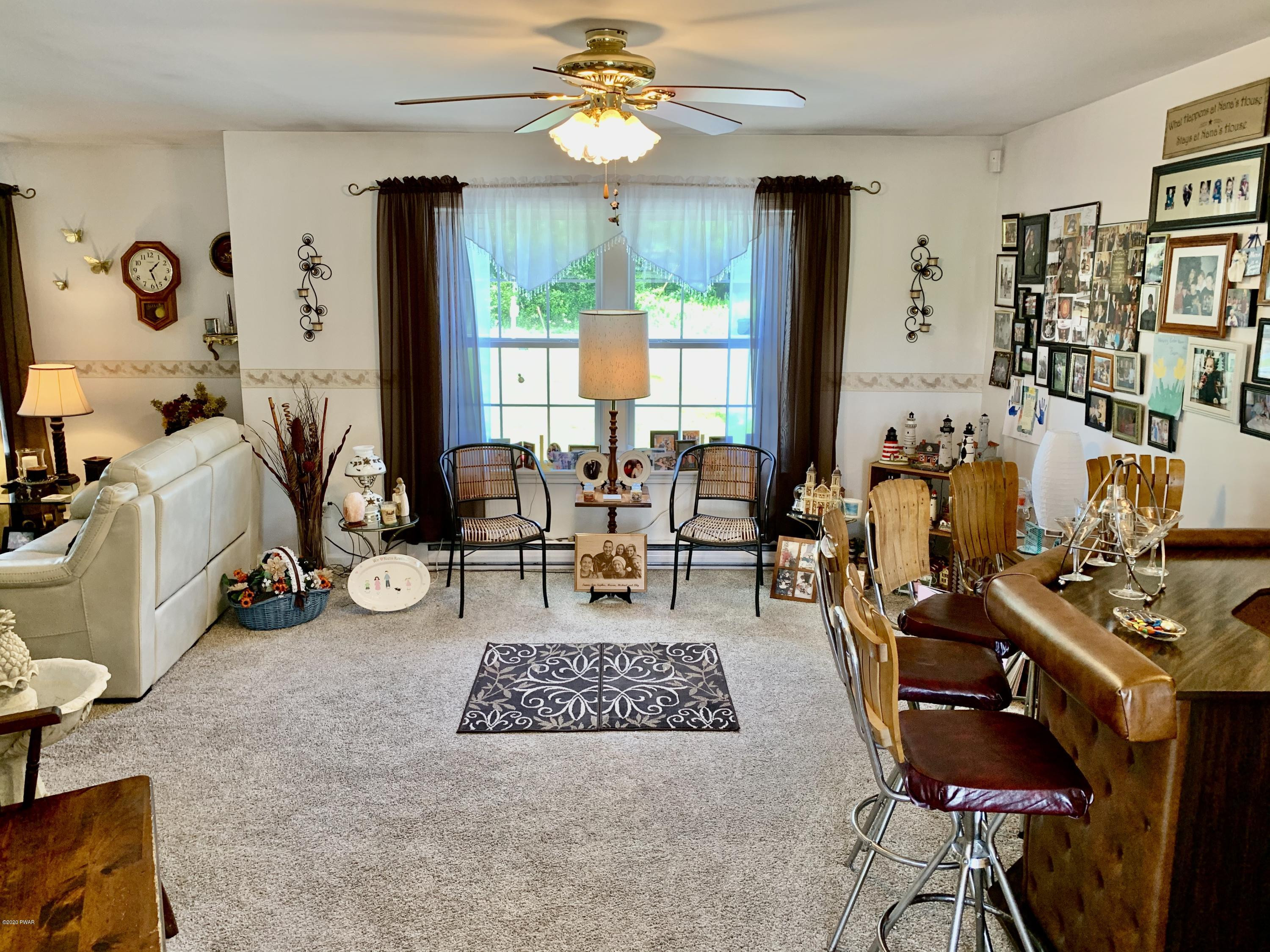 678 Stock Farm Road Lake Ariel, PA 18436 - Photo 18 of 41 a living room with furniture and a large window