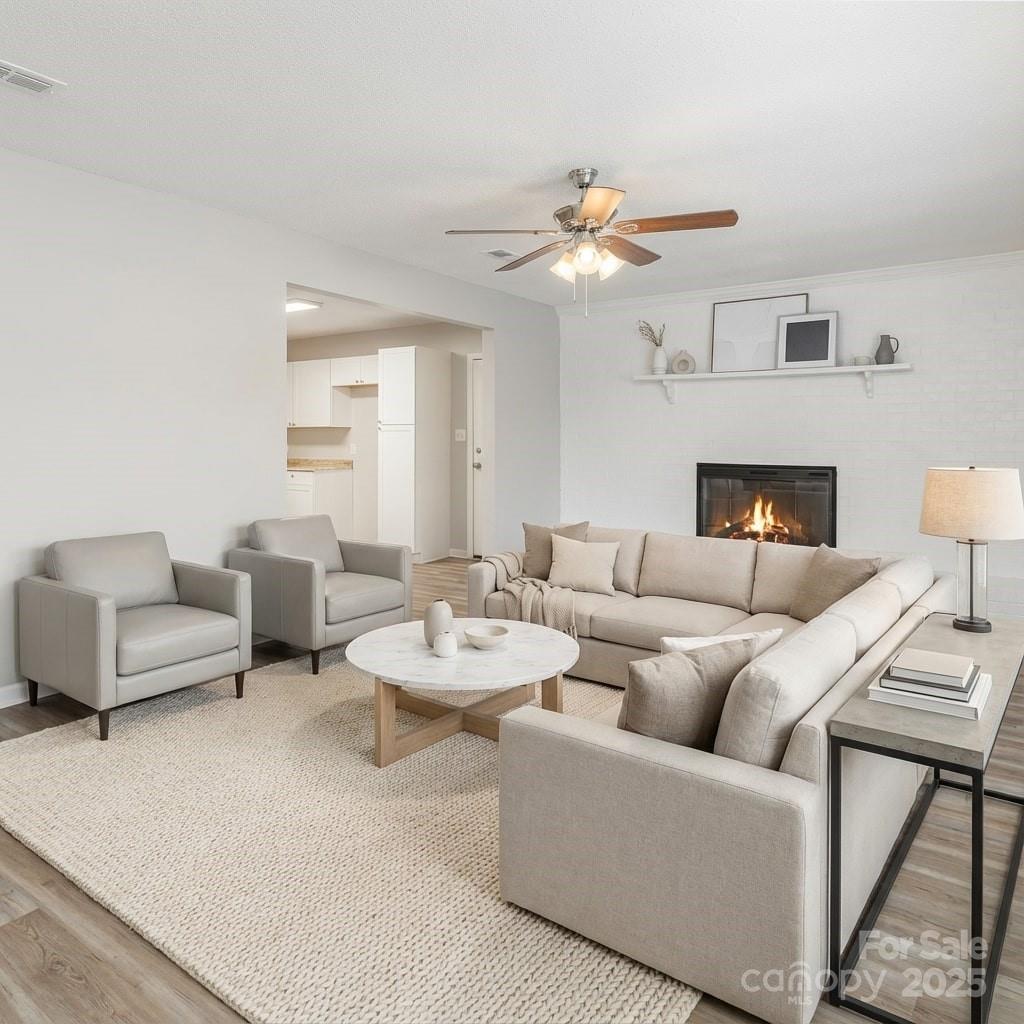 a living room with furniture a fireplace and a chandelier