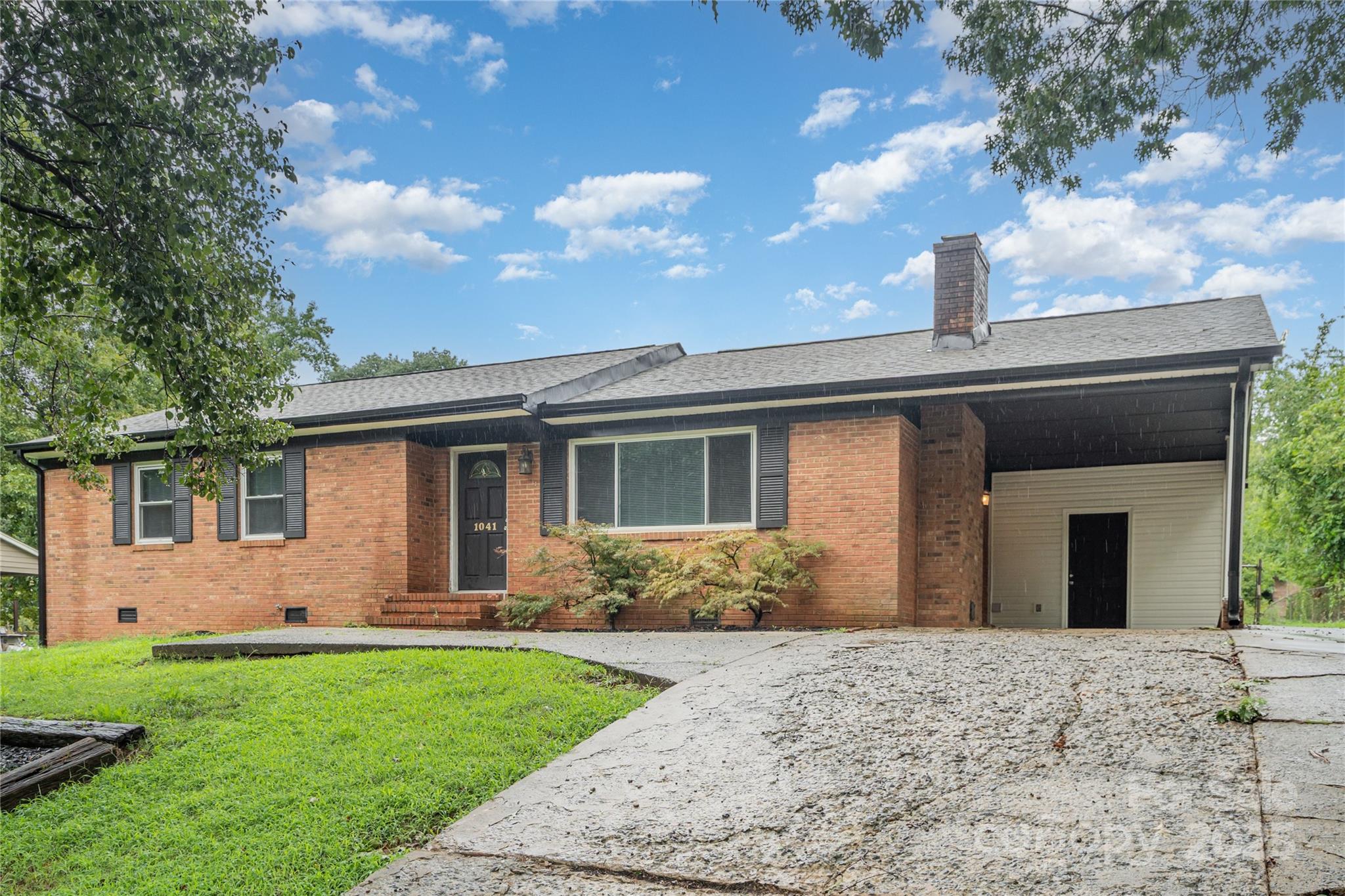 1041 Crowders Creek Road Gastonia, NC 28052 - Photo 6 of 18 a front view of a house with a yard and garage