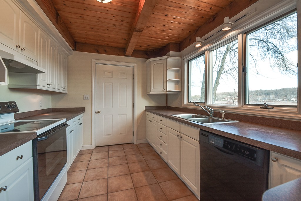 65 Oakhurst Road Hopkinton, MA 01748 - Photo 11 of 27 a kitchen with a sink stove and cabinets