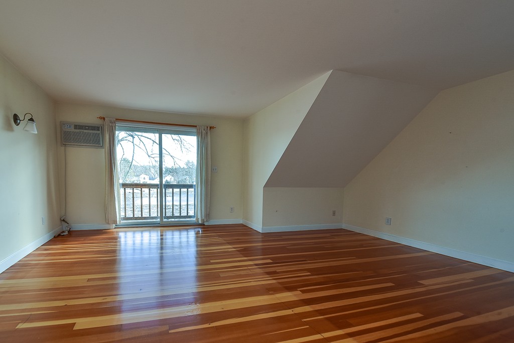 65 Oakhurst Road Hopkinton, MA 01748 - Photo 15 of 27 a view of an empty room with wooden floor and a window