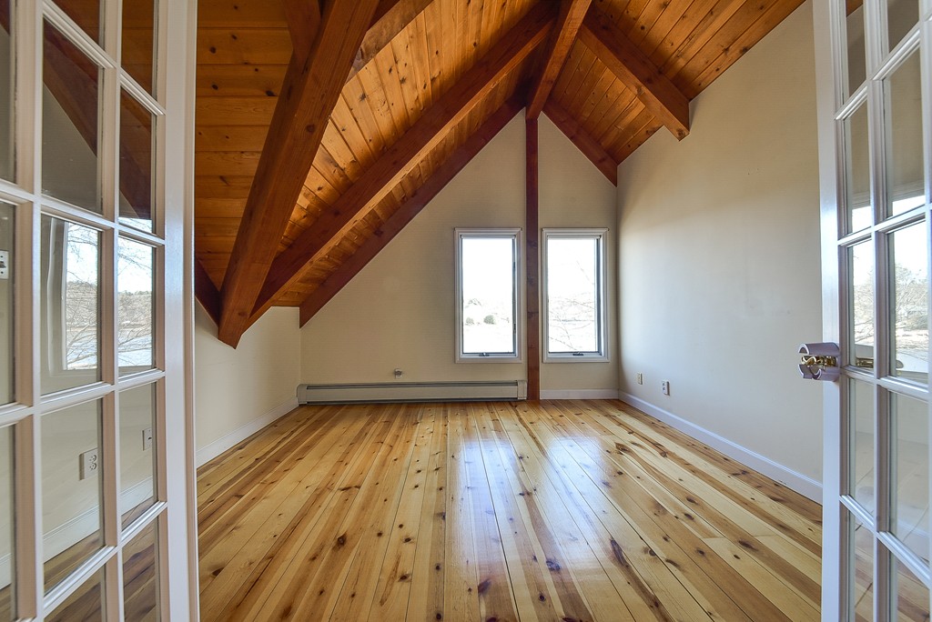 65 Oakhurst Road Hopkinton, MA 01748 - Photo 18 of 27 a view of an empty room with wooden floor and a window