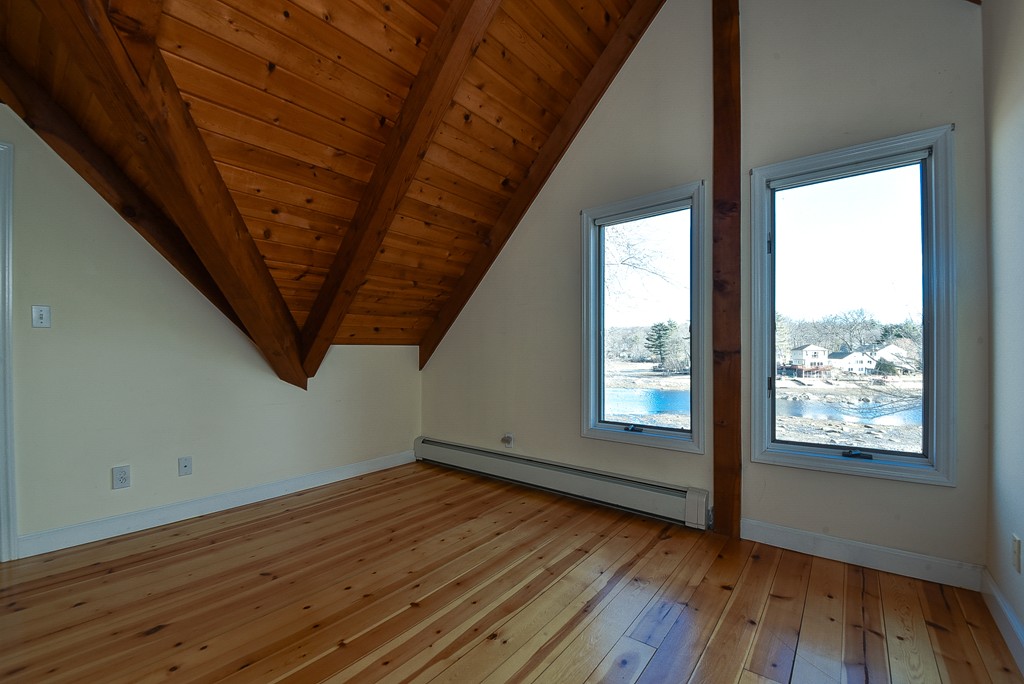 65 Oakhurst Road Hopkinton, MA 01748 - Photo 19 of 27 a view of an empty room with wooden floor and a window