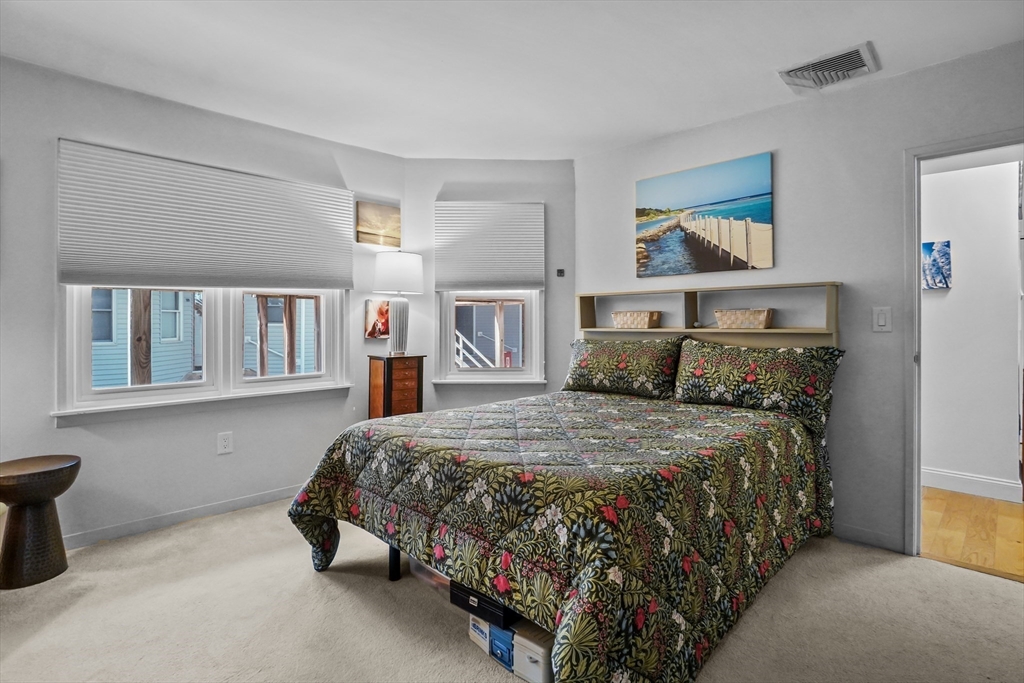 45 Main Street, Unit 112 Wareham, MA 02571 - Photo 12 of 30 a bedroom with a bed and a painting on the wall