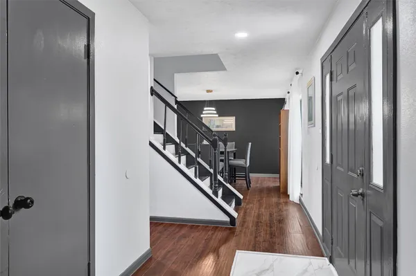 a view of entryway and hall with wooden floor