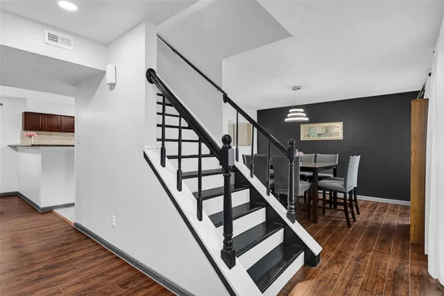 a view of a dining room with furniture and wooden floor