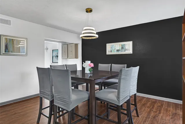 a view of a dining room with furniture and wooden floor