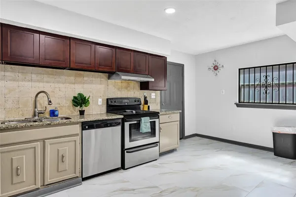 a kitchen with a sink cabinets and stainless steel appliances