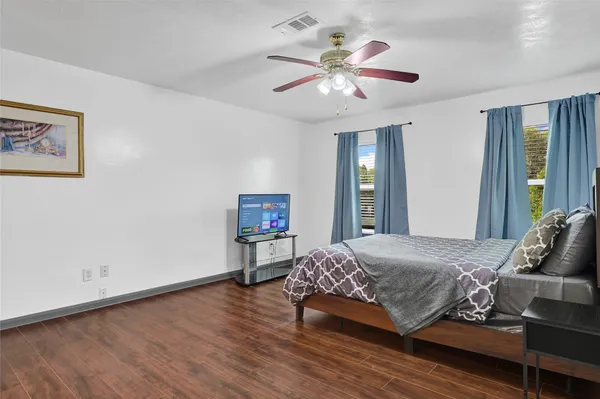 a bedroom with a large bed and a chandelier