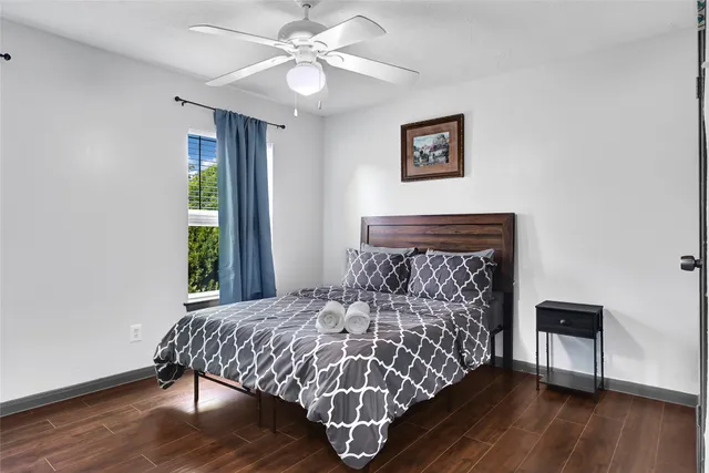 a bed sitting in a bedroom next to a window