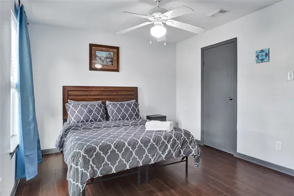 a large bed sitting in a bedroom next to a window