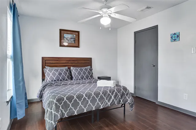 a large bed sitting in a bedroom next to a window
