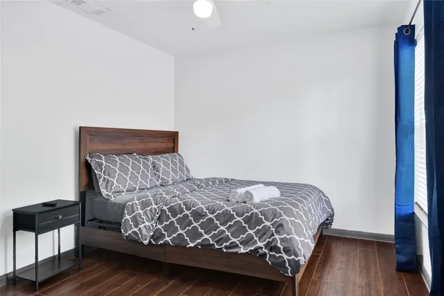 a bedroom with a bed and a chandelier