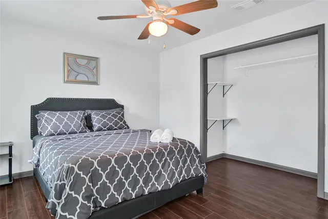 a bedroom with a large bed and a window