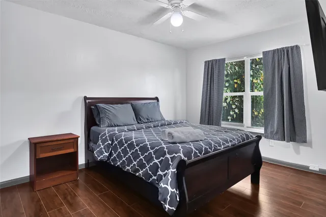 a bedroom with a large bed and a chandelier