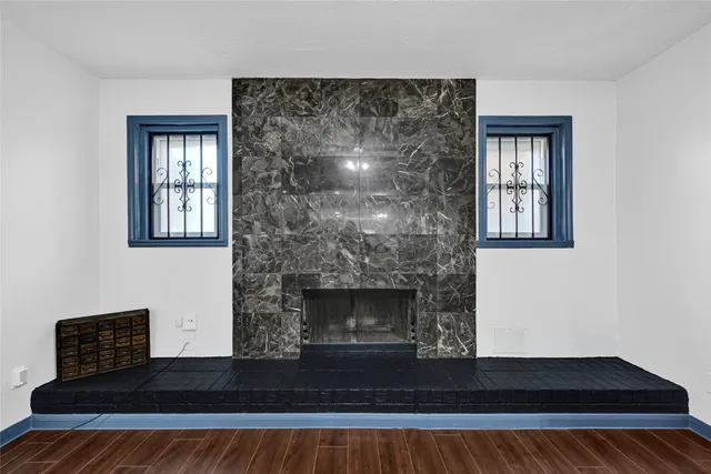 a living room with a fireplace and a window
