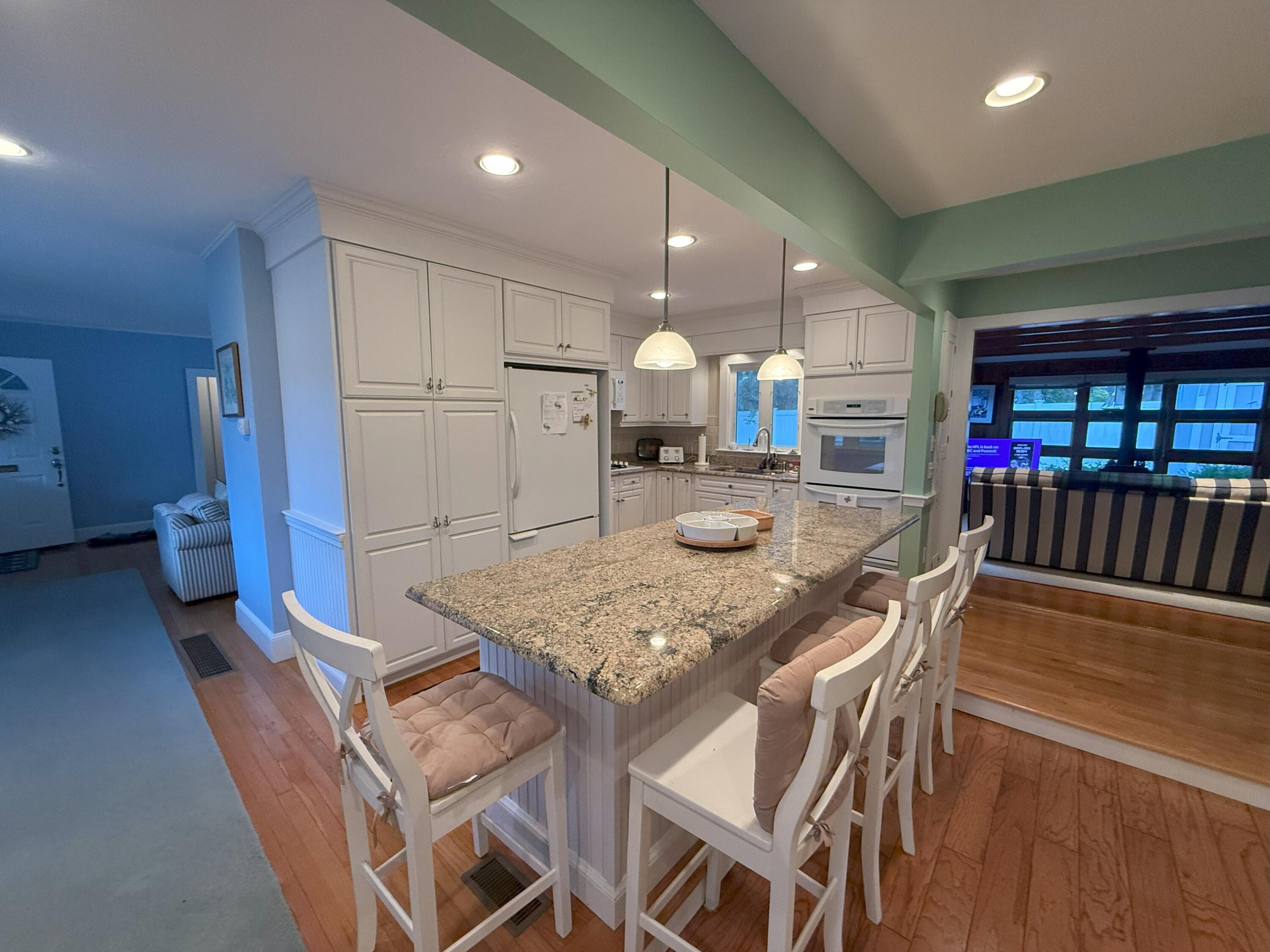 40 Studley Road Hyannis, MA 02601 - Photo 5 of 18 a kitchen with stainless steel appliances granite countertop a table chairs sink and cabinets