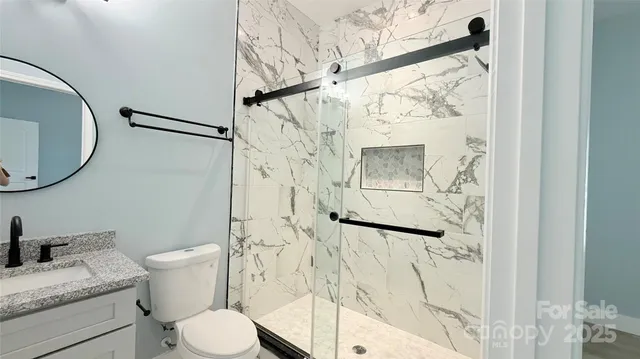 a white toilet sitting next to a bathroom sink