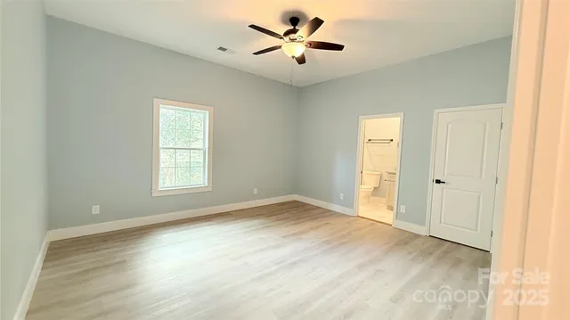 a view of room window and a ceiling fan