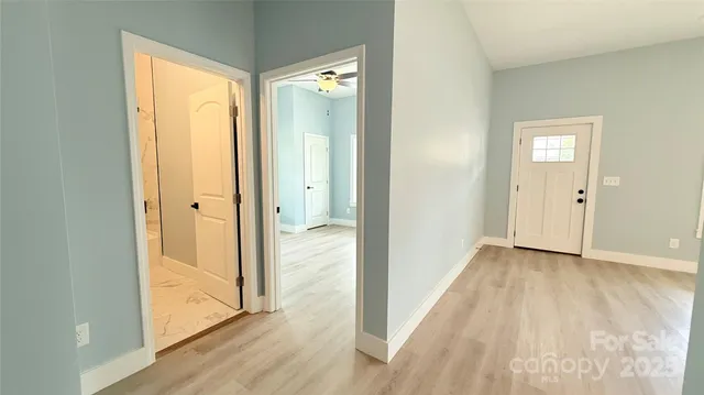 a view of hallway with wooden floor