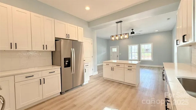 a kitchen with a refrigerator a sink dishwasher with a stove and refrigerator