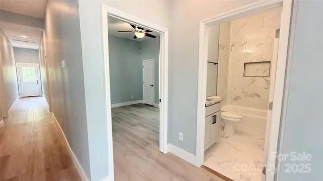 a view of a bathroom from a hallway