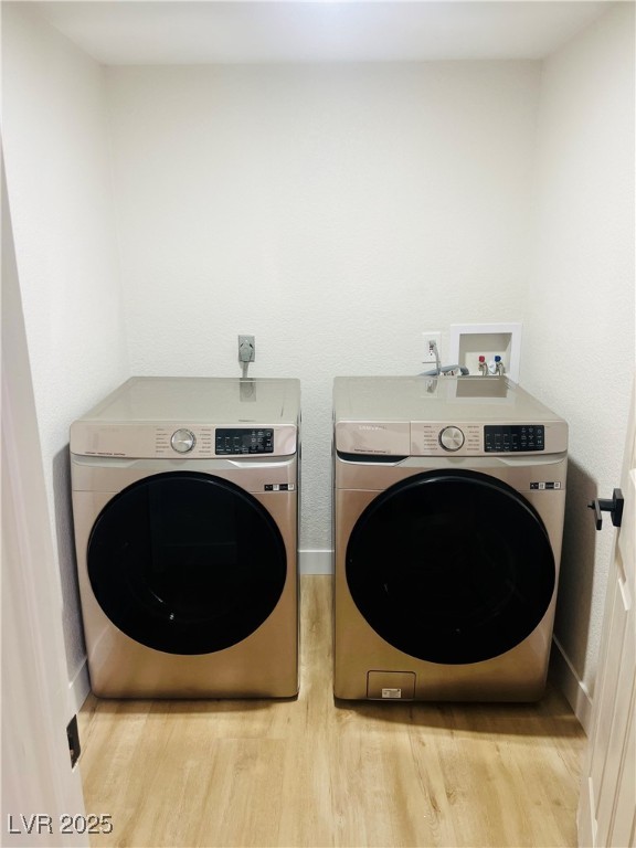 7837 Millhopper Avenue Las Vegas, NV 89128 - Photo 14 of 28 Laundry area with wood finished floors and washer and clothes dryer