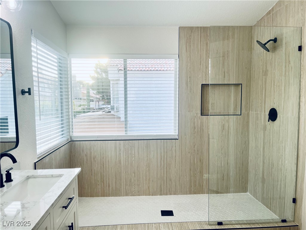 7837 Millhopper Avenue Las Vegas, NV 89128 - Photo 16 of 28 Bathroom with vanity and a tile shower