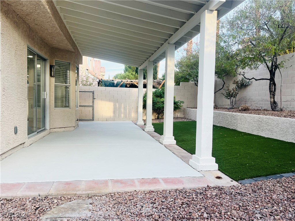 7837 Millhopper Avenue Las Vegas, NV 89128 - Photo 27 of 28 Fenced backyard featuring a patio