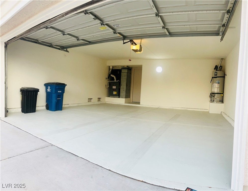 7837 Millhopper Avenue Las Vegas, NV 89128 - Photo 28 of 28 Garage featuring water heater