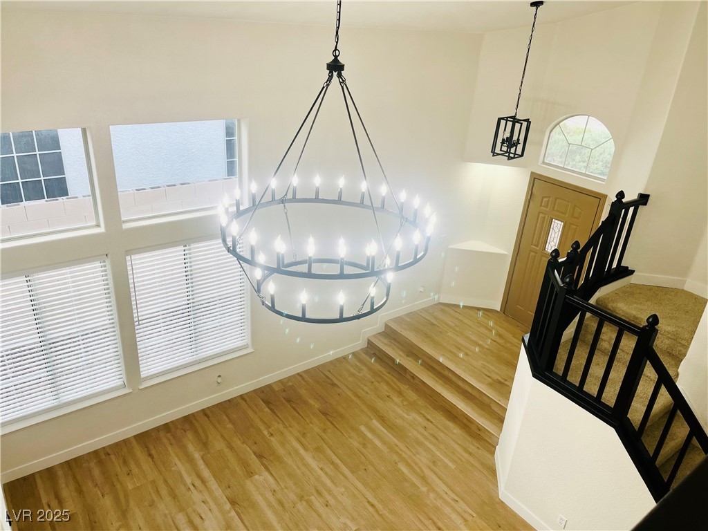 7837 Millhopper Avenue Las Vegas, NV 89128 - Photo 6 of 28 Detailed view of a chandelier and wood finished floors