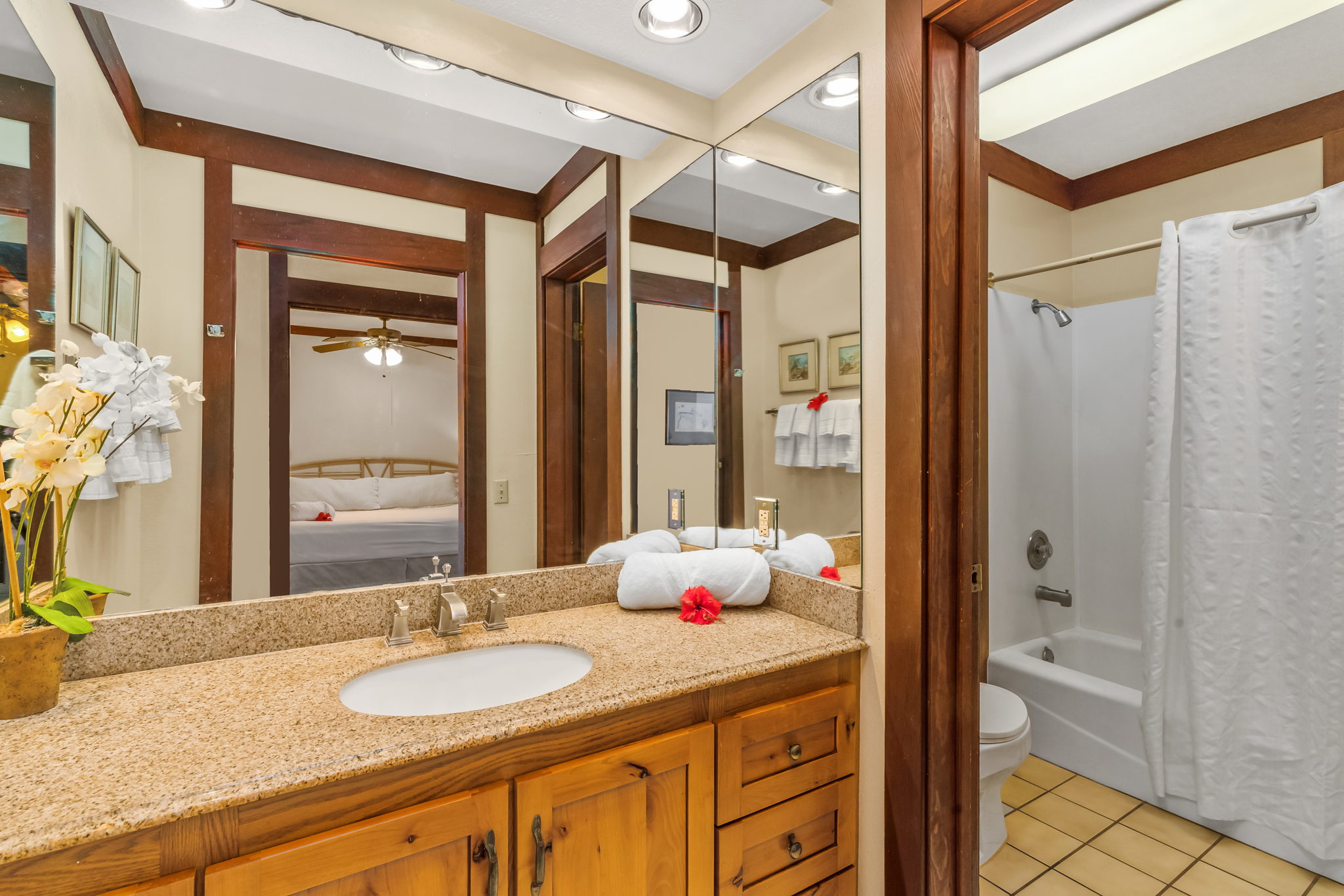 2253 Poipu Road, Unit 109 Koloa, HI 96756 - Photo 3 of 12 a bathroom with a granite countertop sink and a mirror