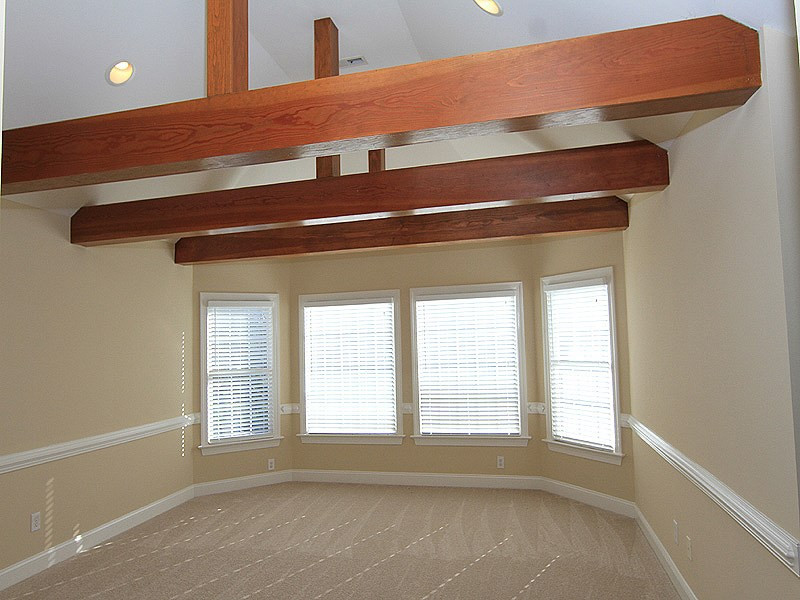 12308 Canolder Street Raleigh, NC 27614 - Photo 22 of 25 This is the extension of the 3rd floor bonus. Beautiful beam accents. There is also a bedroom and an additional office or exercise room along with a full bath on this level.