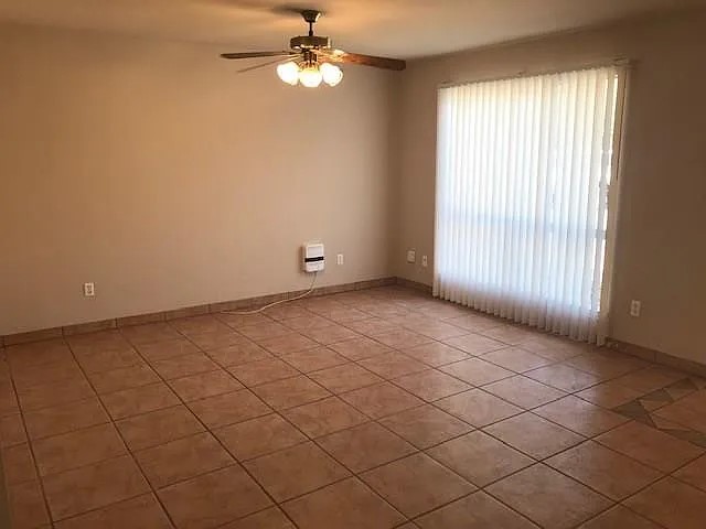 902 Quartz Court, Unit B Cedar Park, TX 78613 - Photo 2 of 12 an empty room with windows and fan