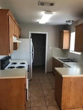 a kitchen that has a sink and a stove
