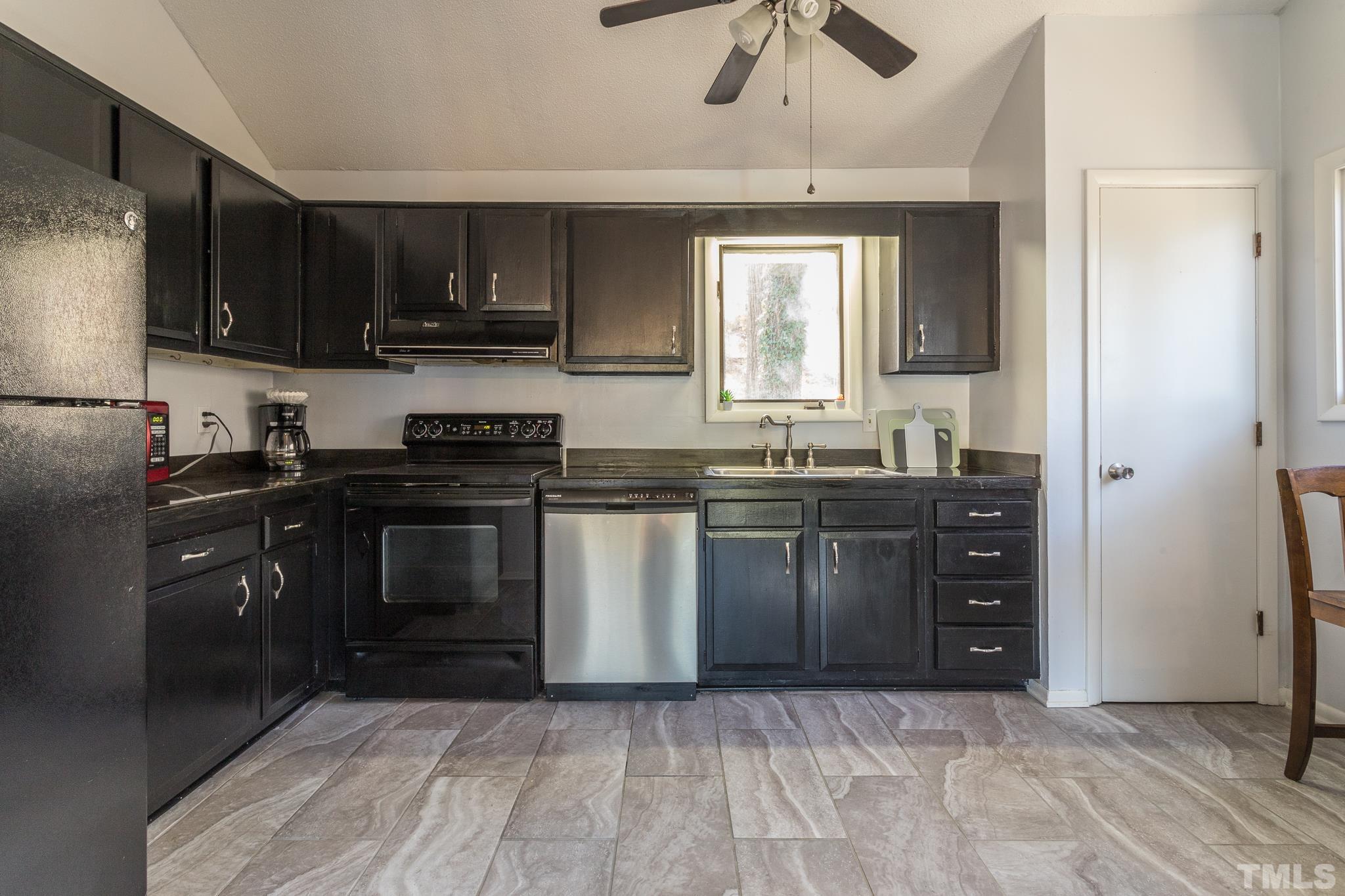 372 Cedar Lake Road Chapel Hill, NC 27516 - Photo 14 of 42 a kitchen with stainless steel appliances granite countertop a stove a sink and a refrigerator