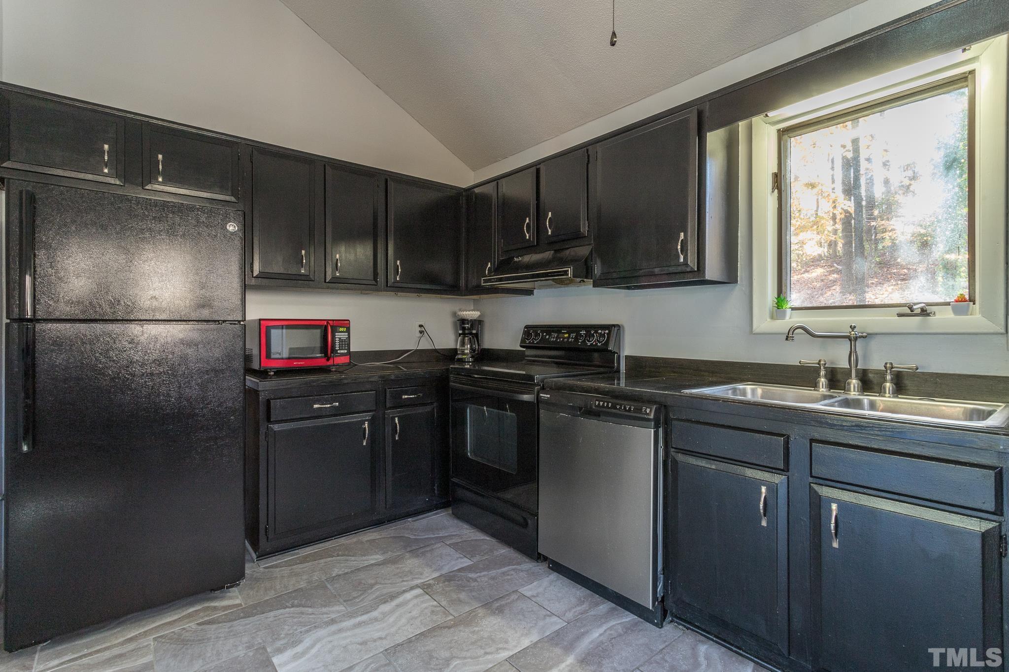 372 Cedar Lake Road Chapel Hill, NC 27516 - Photo 15 of 42 a kitchen with stainless steel appliances granite countertop a refrigerator sink and stove