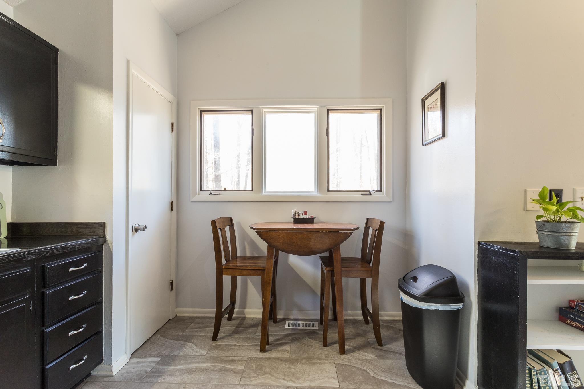 372 Cedar Lake Road Chapel Hill, NC 27516 - Photo 17 of 42 a view of a dining room with furniture and wooden floor