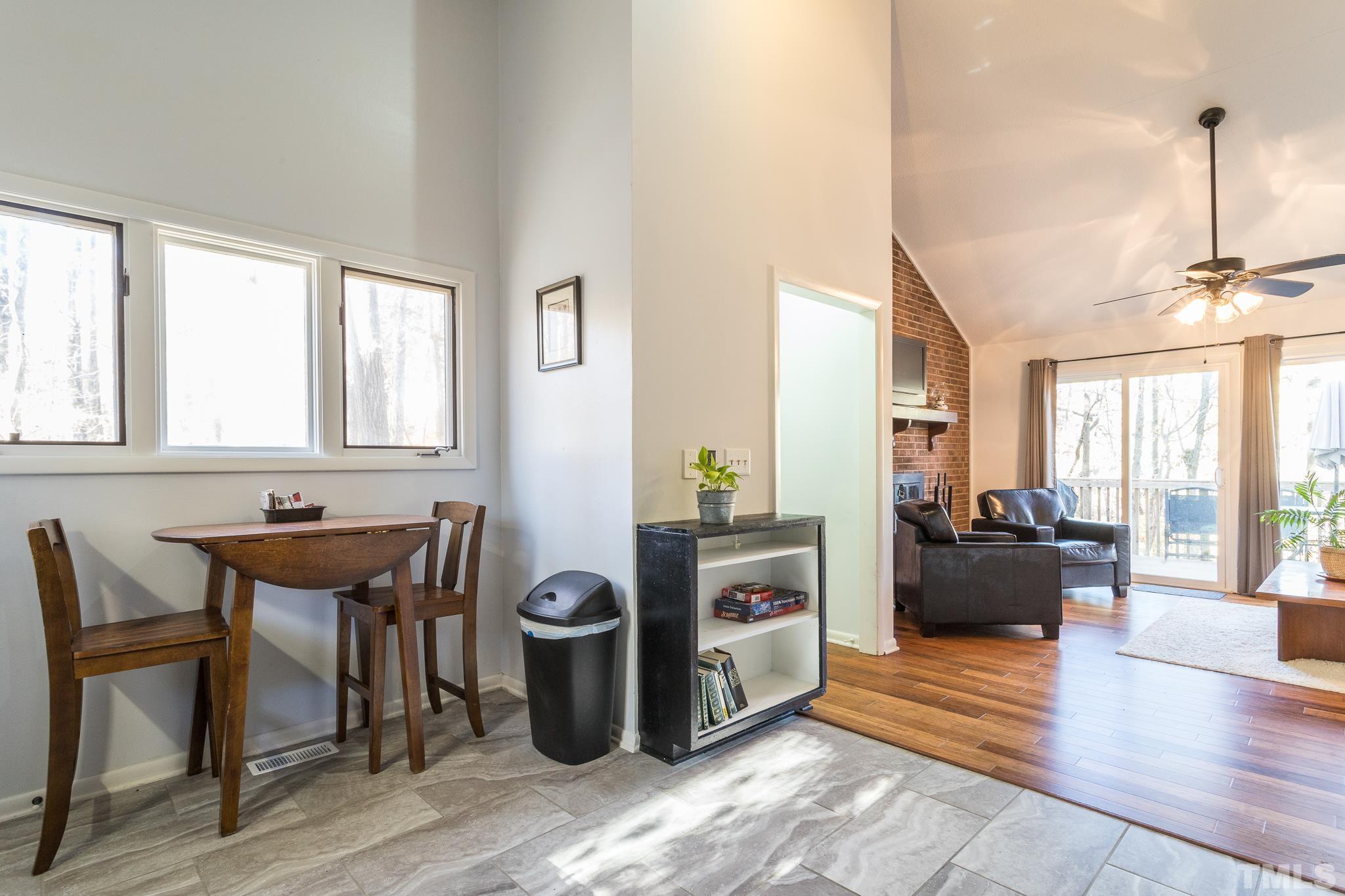372 Cedar Lake Road Chapel Hill, NC 27516 - Photo 18 of 42 a view of a dining room with furniture and wooden floor