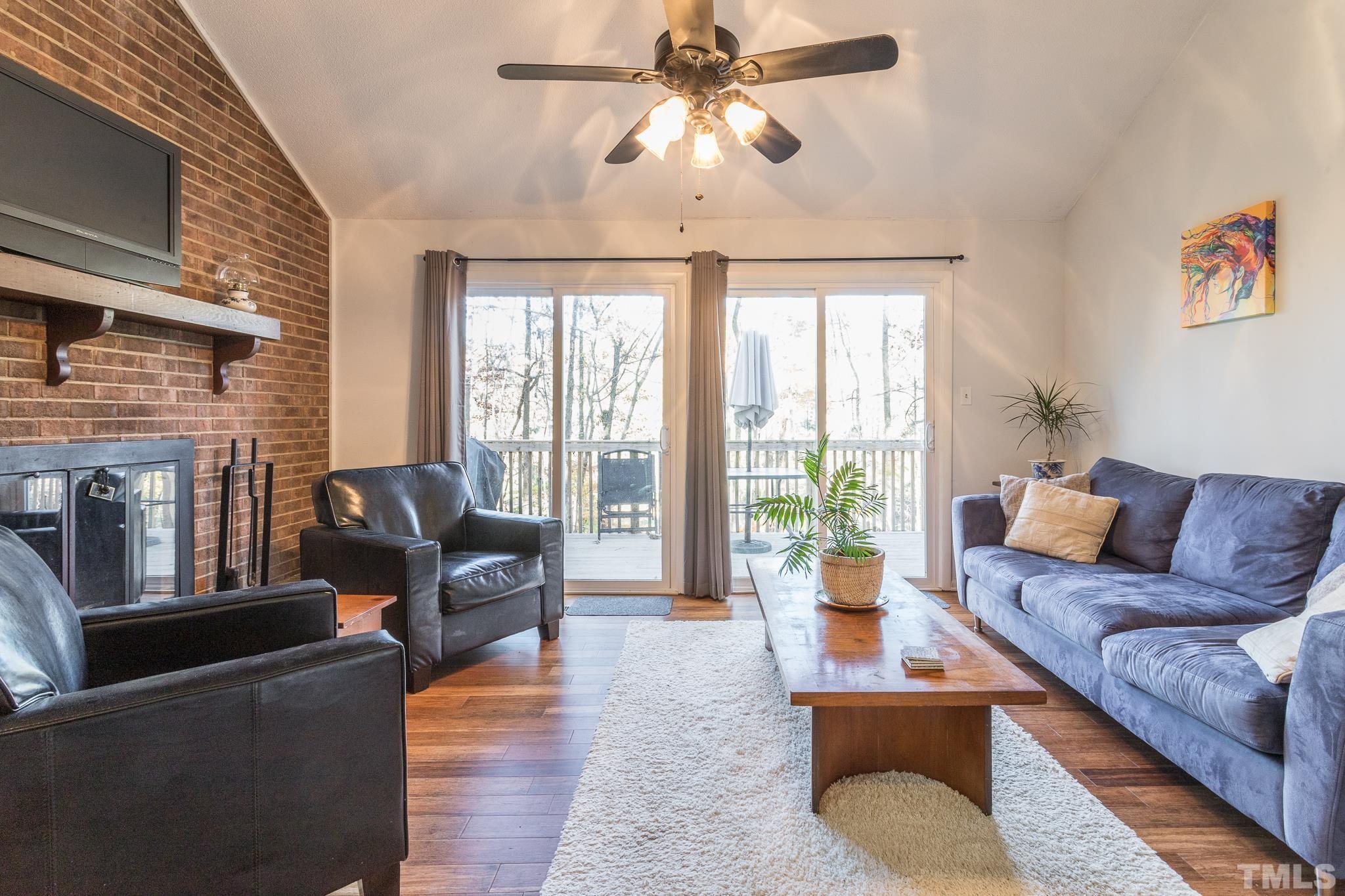 372 Cedar Lake Road Chapel Hill, NC 27516 - Photo 20 of 42 a living room with furniture and a fireplace