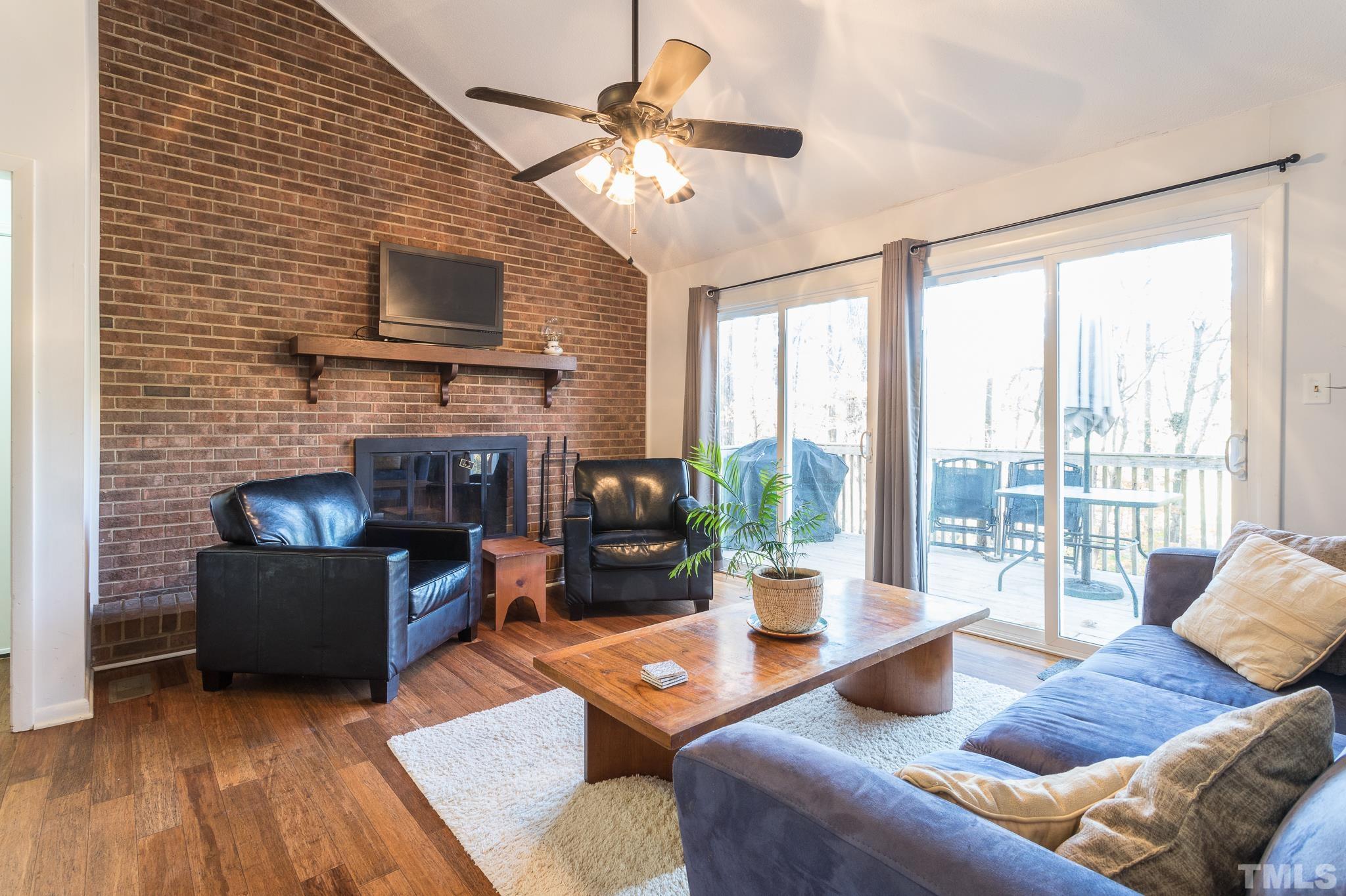 372 Cedar Lake Road Chapel Hill, NC 27516 - Photo 21 of 42 a living room with fireplace furniture and a flat screen tv