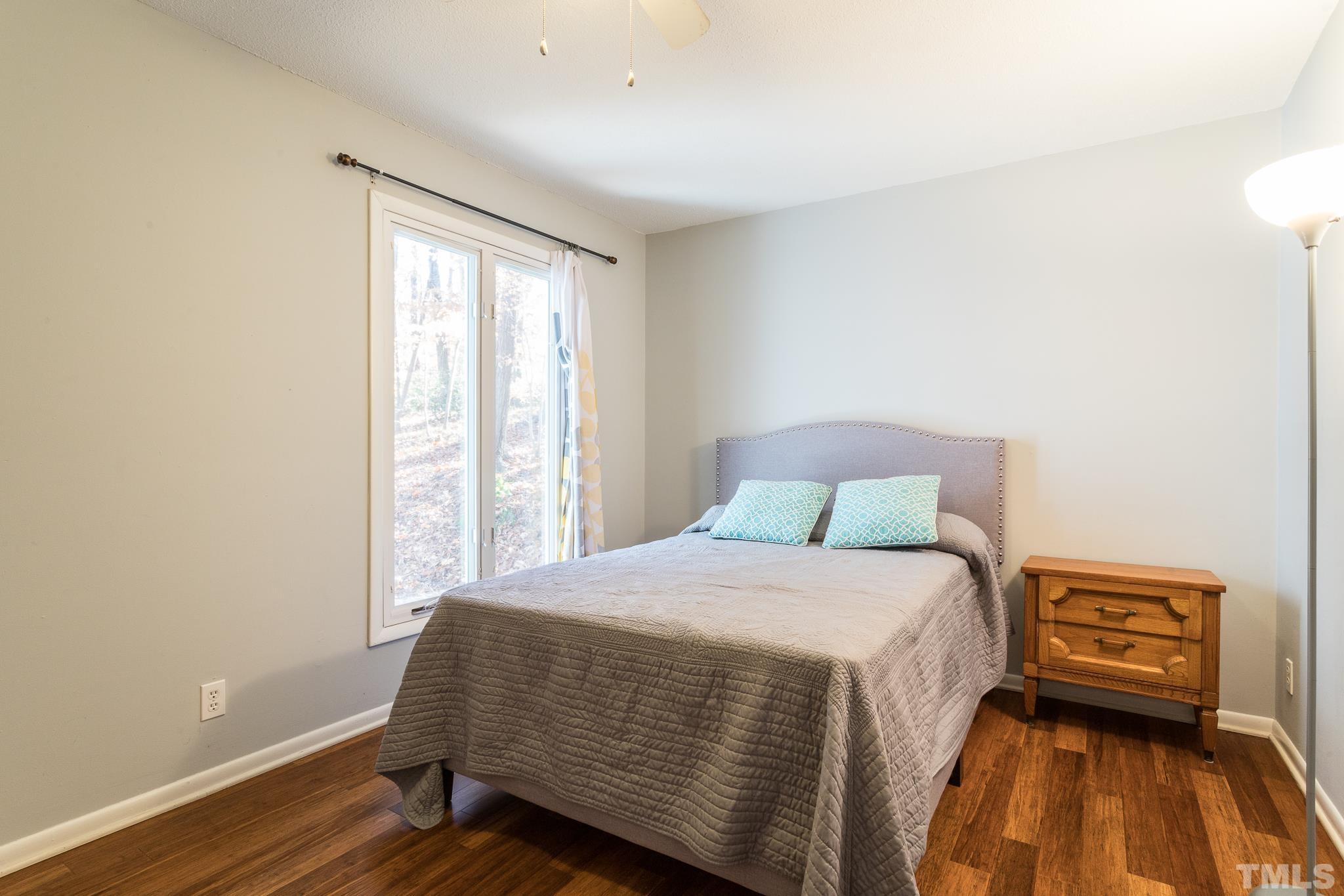 372 Cedar Lake Road Chapel Hill, NC 27516 - Photo 25 of 42 a bedroom with a bed and wooden floor