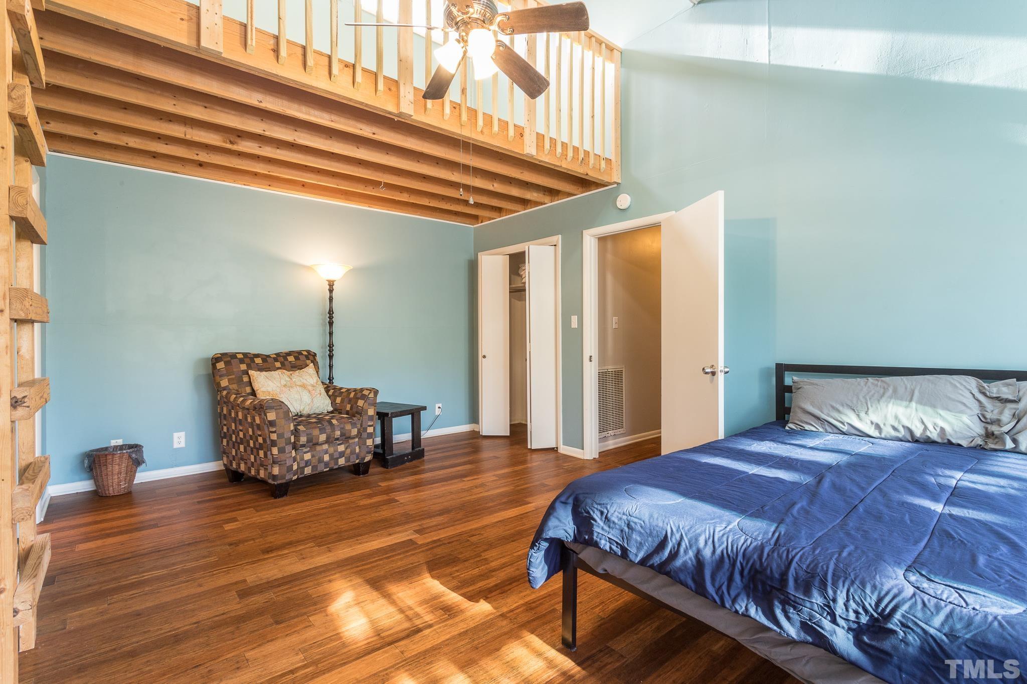372 Cedar Lake Road Chapel Hill, NC 27516 - Photo 28 of 42 a bedroom with a bed and a chandelier