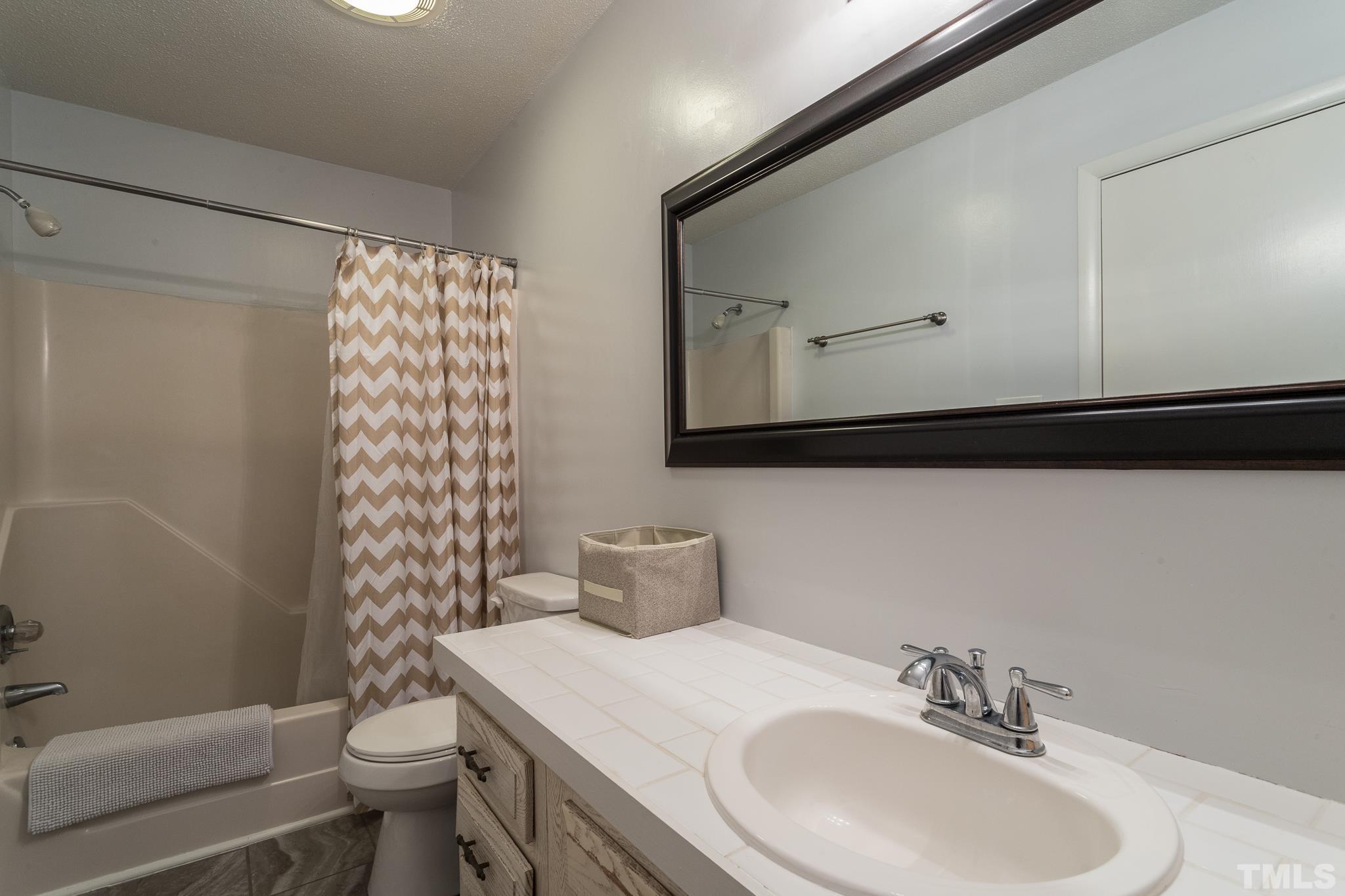 372 Cedar Lake Road Chapel Hill, NC 27516 - Photo 31 of 42 a bathroom with a sink toilet and shower