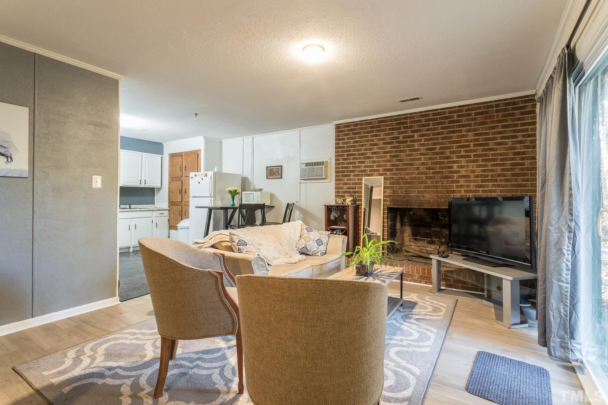 372 Cedar Lake Road Chapel Hill, NC 27516 - Photo 33 of 42 a dining room with furniture and a flat screen tv